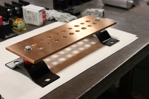 Copper Bus Bar Assembly sitting on table